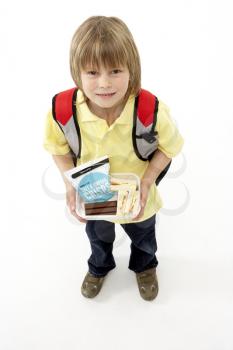 Studio Portrait of Smiling Boy Holding Lunchbox