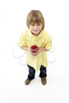 Studio Portrait of Smiling Boy Holding Glass of Fruit Juice