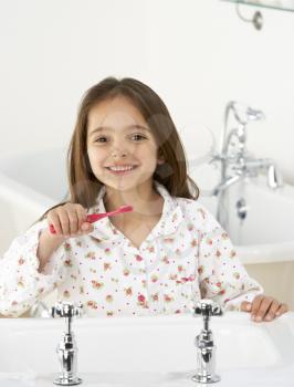 Royalty Free Photo of a Girl Brushing Her Teeth