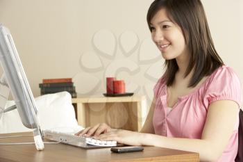 Royalty Free Photo of a Girl on the Computer at Home
