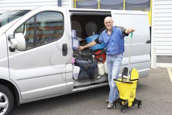 Royalty Free Photo of a Cleaner Next to a Van