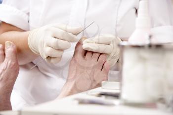 Royalty Free Photo of a Chiropodist Treating a Patient