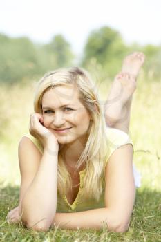 Royalty Free Photo of a Young Woman Lying on the Grass