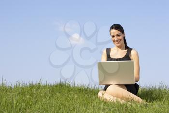 Royalty Free Photo of a Woman Outside With a Laptop