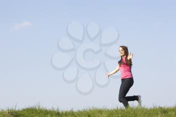 Royalty Free Photo of a Girl Running in a Field