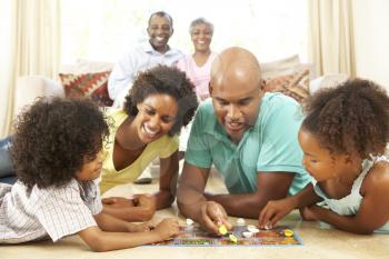 Royalty Free Photo of a Family on the Floor Playing Games