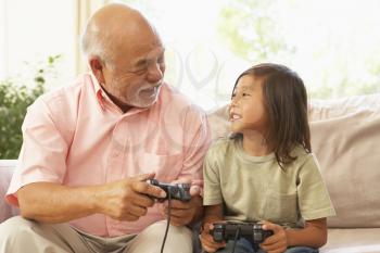 Royalty Free Photo of a Grandfather and Grandson Playing Video Games