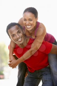 Royalty Free Photo of a Couple Having Fun Outdoors