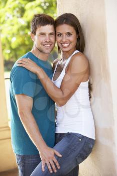 Royalty Free Photo of a Couple Leaning Against a Wall