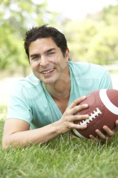 Royalty Free Photo of a Man on the Grass With a Football
