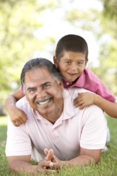 Royalty Free Photo of a Grandfather and Grandson on the Grass