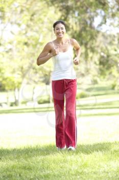 Royalty Free Photo of a Woman Jogging in a Park