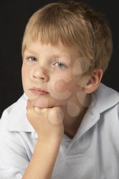 Studio Portrait Of Thoughtful Young Boy