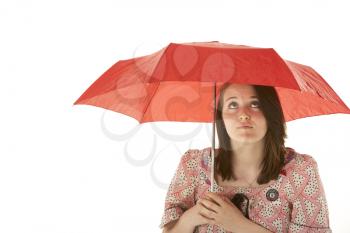 Studio Shot Of Teenage Girl Standing Under Red Umbrella