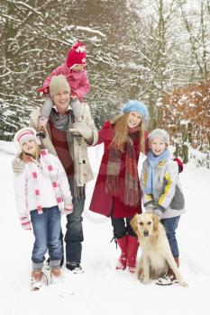 Family Walking Through Snowy Woodland