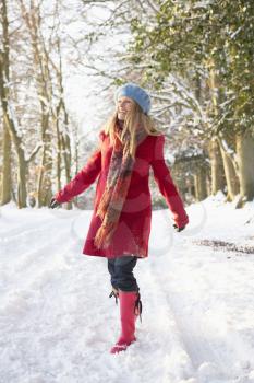 Woman Walking Through Snowy Woodland