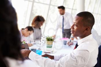 African American Businessman At Meeting With Colleagues