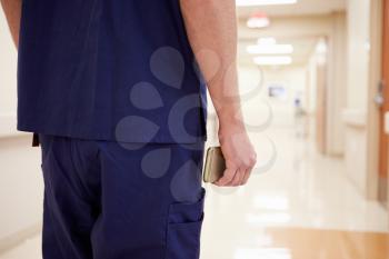 Close Up Of Nurse With Cellphone In Hospital Corridor