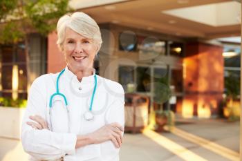 Portrait Of Female Doctor Standing Outside Hospital