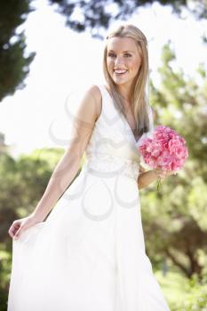 Bride Wearing Dress Holding Bouqet At Wedding