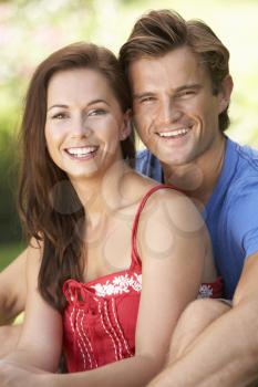 Portrait Of Young Couple Relaxing In Park