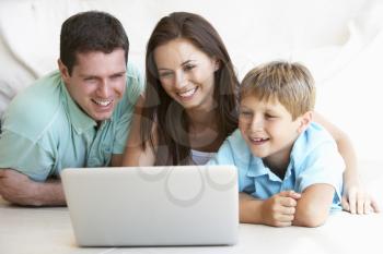Young parents, with child, on laptop computer