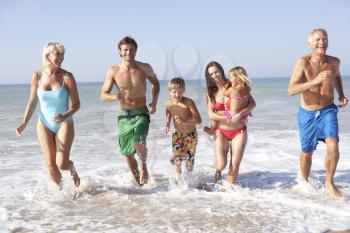 Three generation family play on beach