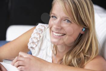 Studio Portrait Of Teenage Girl Listening to MP3 Player
