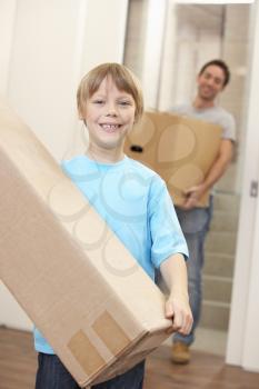 Boy with young man on moving day carrying cardboard box