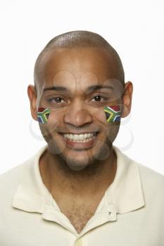 Young Male Sports Fan With South African Flag Painted On Face