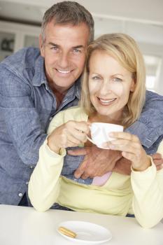 Mid age couple with coffee at home