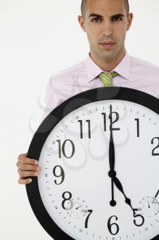 Young businessman with giant clock