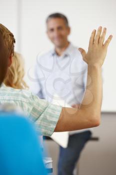 Student with hand up in class
