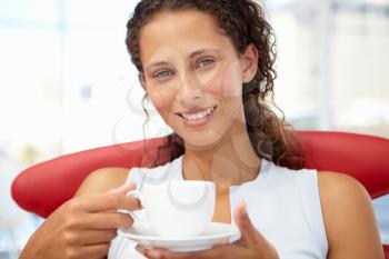 Young woman relaxing with cup of tea