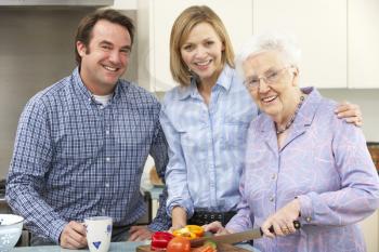 Senior woman and family preparing meal together