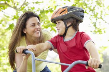 Boy on bike with mother
