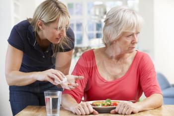 Older woman refusing medication at home