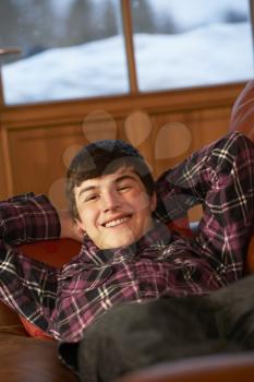 Teenage Boy Relaxing On Sofa