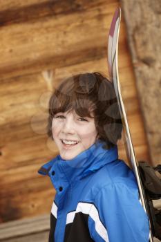 Boy With Snowboard On Ski Holiday In Front Of Wooden Background