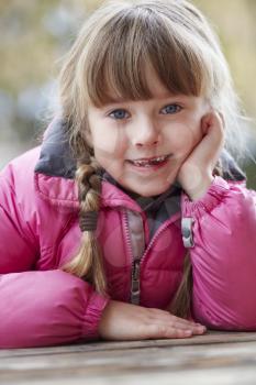Outdoor Portrait Of Young Girl Wearing Winter Clothes
