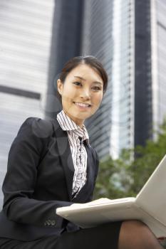 Chinese Businesswoman Working On Laptop Outside Office