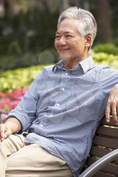 Senior Chinese Man Relaxing On Park Bench