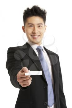 Studio Portrait Of Chinese Businessman Offering Business Card