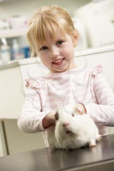 Child Taking Guinea Pig To Veterinary Surgery For Examination