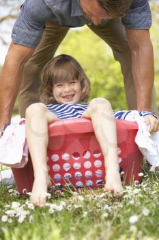 Father Carrying Son Sitting In Laundry Basket
