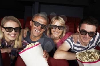 Teenage Family Watching Film In Cinema