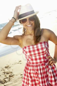 Attractive Teenage Girl Wearing Dress On Beach Holiday