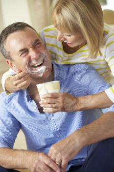 Senior Woman Feeding Husband Ice Cream