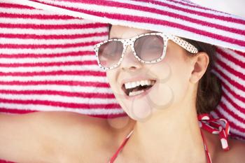 Woman Sheltering From Sun On Beach Holiday