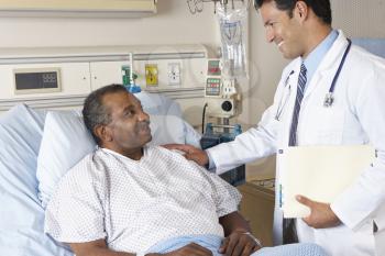 Doctor Visiting Senior Male Patient On Ward
